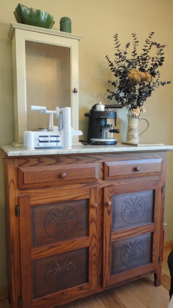 Speaking of country, I love how my Amish-made sideboard fits into the whole scheme. The copper door inserts became a theme, so we've tried to incorporate copper in the kitchen wherever we can. 